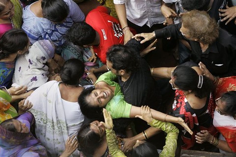 Relatives and neighbors mourn as they attend the funeral of Haresh Gohil, a 16 year old boy who was killed by gunmen near Chabad-Lubavitch center,also known as Nariman House in Mumbai, India, Saturday, Nov. 29, 2008. Indian commandos killed the last remaining gunmen holed up at a luxury Mumbai hotel Saturday, ending a 60-hour rampage through India's financial capital by suspected Islamic militants that rocked the nation.(AP Photo/Gurinder Osan)