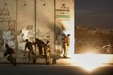 thumbnail: Israeli soldiers run away to avoid a stun grenade thrown by another soldier by mistake during clashes with Palestinians, following a demonstration against the Israeli missiles strike on Gaza, at the Kalandia checkpoint between the West Bank city of Ramallah and Jerusalem Saturday, Dec. 27, 2008. Israeli warplanes attacked dozens of security compounds across Hamas-ruled Gaza on Saturday in unprecedented waves of air strikes. Gaza medics said at least 145 people were killed and more than 310 wounded in the single deadliest day in Gaza fighting in recent memory. (AP Photo/Muhammed Muheisen)