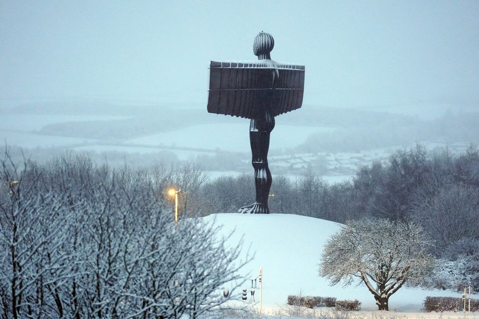 Snow surrounds the Angel of the North in Gateshead (Owen Humphreys/PA)