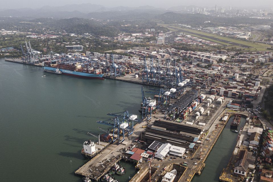 Cargo containers sit stacked as cranes load and unload containers from cargo ships at the Panama Canal’s Balboa port (AP/Matias Delacroix)