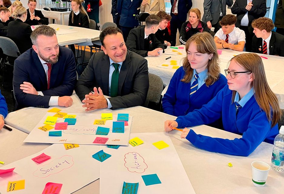 SDLP leader Colum Eastwood (left) and former taoiseach Leo Varadkar (second left) talking to schoolchildren during an event at Derry's Playhouse theatre hosted by the SDLP's New Ireland Commission exploring youth perspectives on the constitutional future of the island of Ireland. Image: David Young/PA Wire