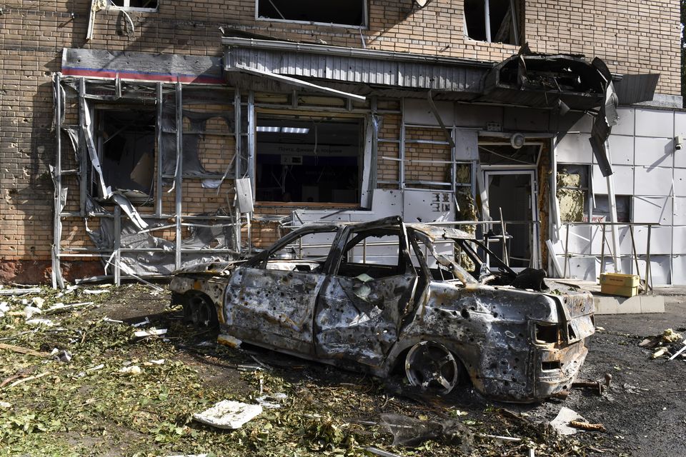 A burned car is seen in front of an apartment building damaged after shelling by the Ukrainian side in Kursk (AP/PA)