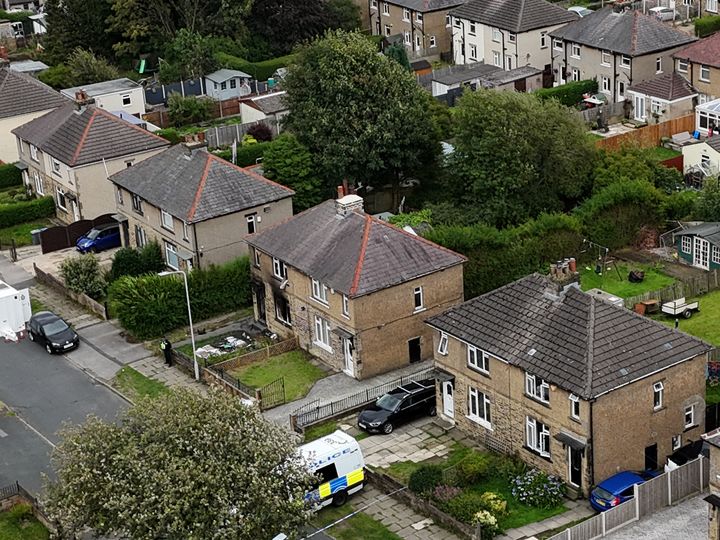 Two men appear in court charged with murdering mother and children in house fire