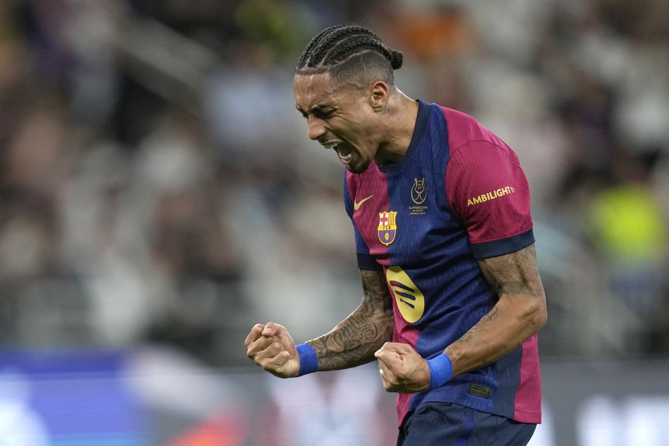 Raphinha scored twice and set up another goal as Barcelona beat Real Madrid 5-2 in the Spanish Super Cup final in Saudi Arabia (Altaf Qadri/AP)