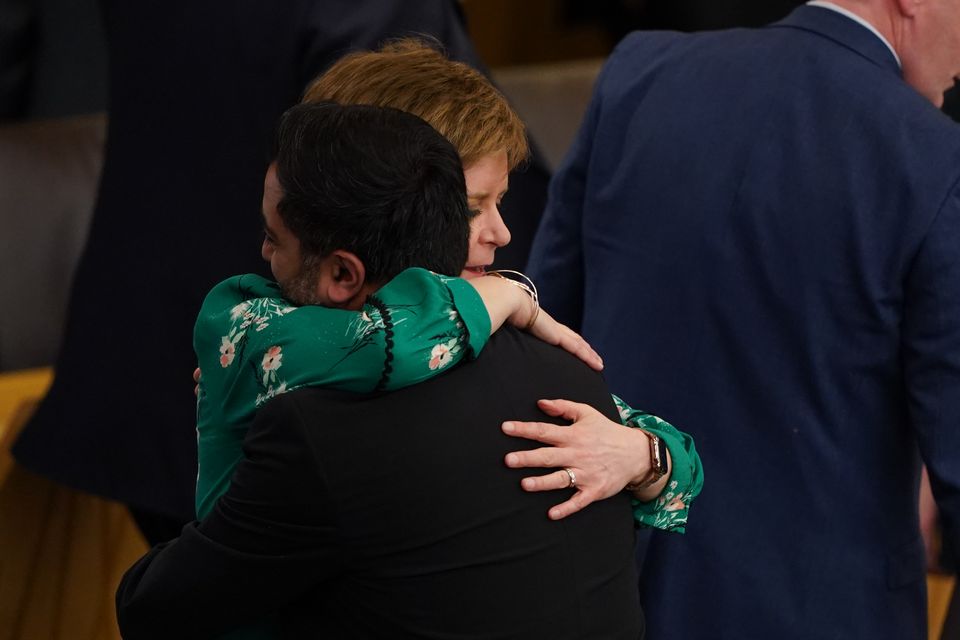 Mr Yousaf embraces Nicola Sturgeon after his final speech in Holyrood as first minister in May this year (Andrew Milligan/PA)