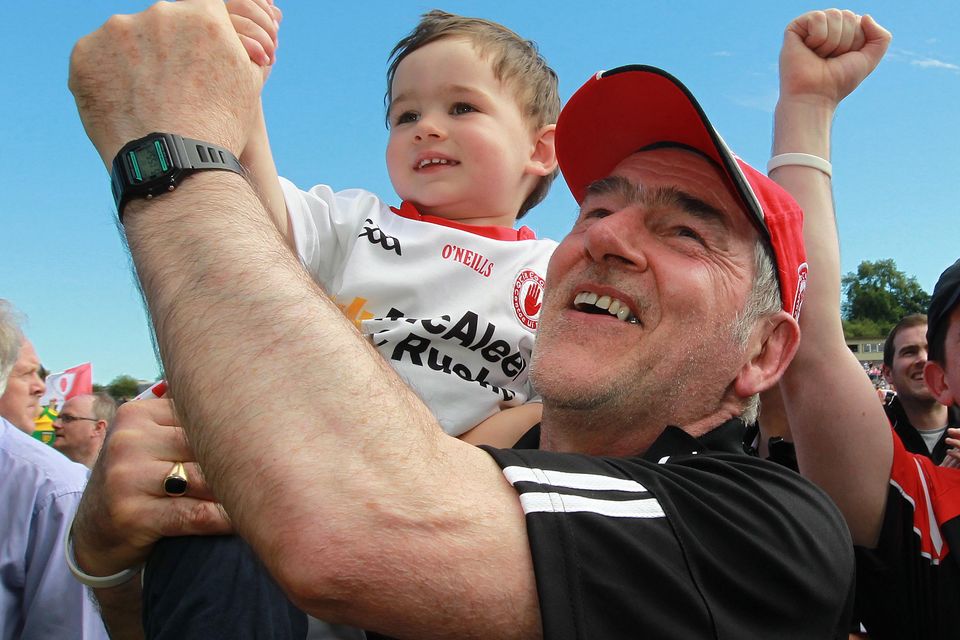 Unclear future: Mickey Harte, pictured celebrating with grandson Michael after winning the Ulster title, is in limbo