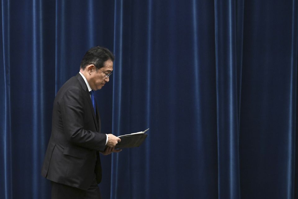 Japan’s Prime Minister Fumio Kishida leaves a press conference at his office in Tokyo after he announced he will not run (Philip Fong/AP)