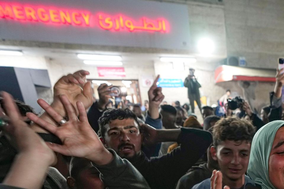 Palestinians celebrate the announcement of a ceasefire deal between Hamas and Israel in Deir al-Balah, central Gaza (Abdel Kareem Hana/AP)