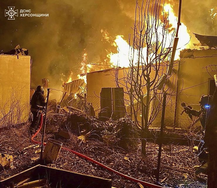 Firefighters deal with a fire following a Russian attack in Kherson on Saturday (Ukrainian Emergency Service via AP)