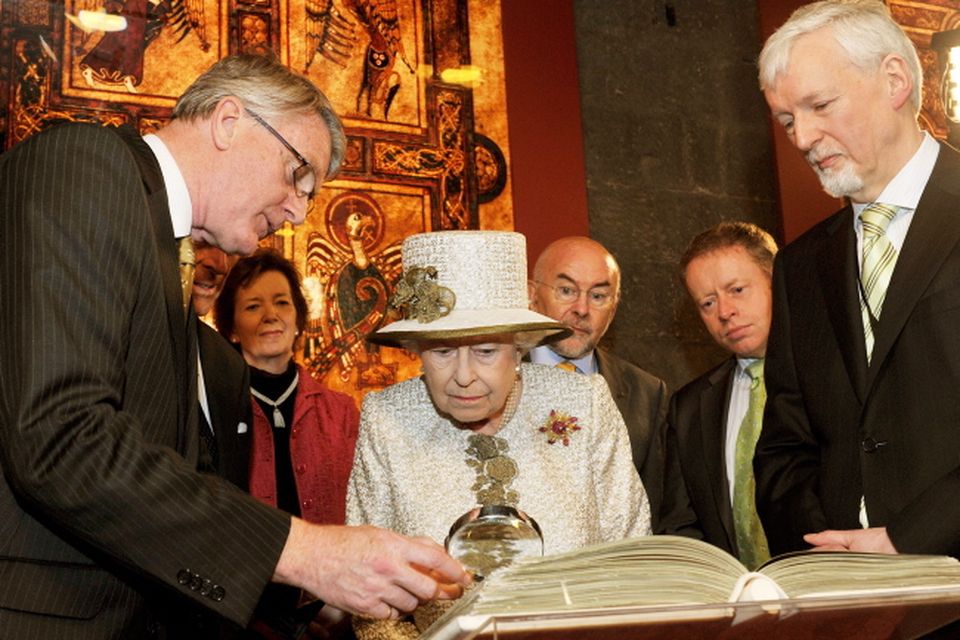 Queen Elizabeth II  and Prince Philip, Duke of Edinburgh are shown the Book of Kells during a visit to Trinity College Dublin on May 17