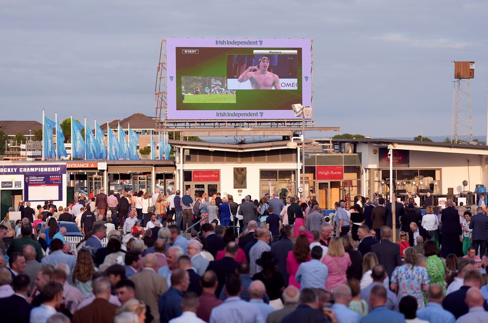 Racegoers at Galway Racecourse watch Ireland’s Daniel Wiffen on the big screen as he wins the men’s 800m freestyle final at the Paris Olympic Games (Niall Carson/PA)