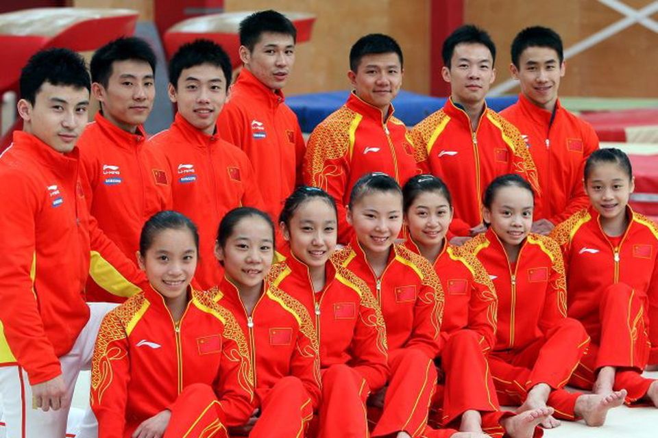 The Chinese Olympic gymnastic team pose for a photograph after a training session at Salto Gym in Lisburn, Co Antrim. PRESS ASSOCIATION Photo. Picture date: Wednesday July 18, 2012. Photo credit should read: Paul Faith/PA Wire.
