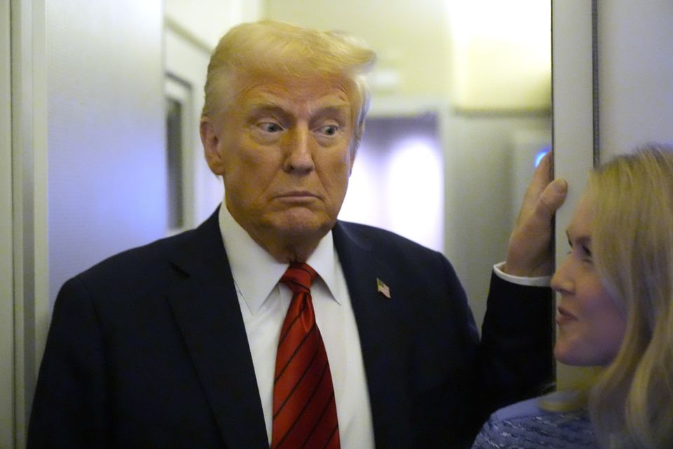 President Donald Trump speaks to reporters aboard Air Force One en route from Miami to Joint Base Andrews (AP/Mark Schiefelbein)