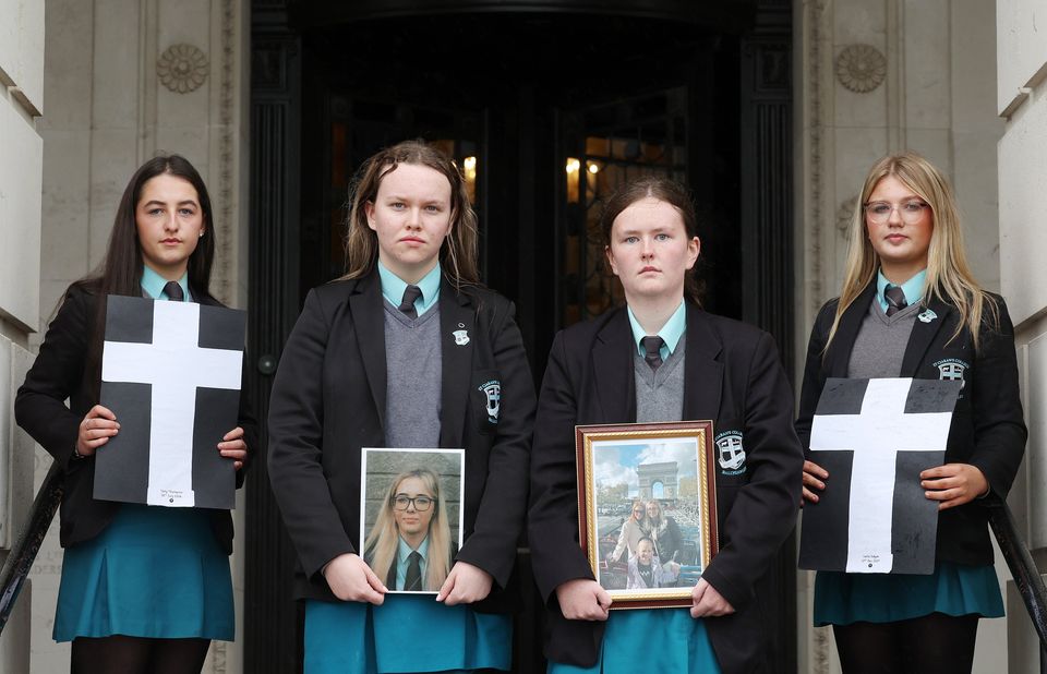 Left to right, pupils Rosie McCabe, Dearbhla McAnenly, Eadaon Nugent and Rebecca McCann holds crosses and photographers of Kamile Vaicikonyte (Credit: PressEye)