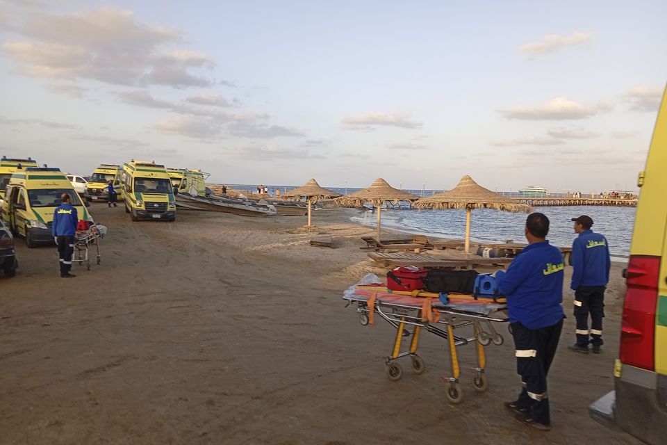 Rescuers wait on the beach of Marsa Alam (AP)