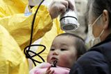 thumbnail: A baby is checked for radiation exposure level in Nihonmatsu in Fukushima prefecture (state) Tuesday, March 15, 2011 following a third explosion at the Fukushima Dai-ichi nuclear power complex Tuesday, March 15, 2011