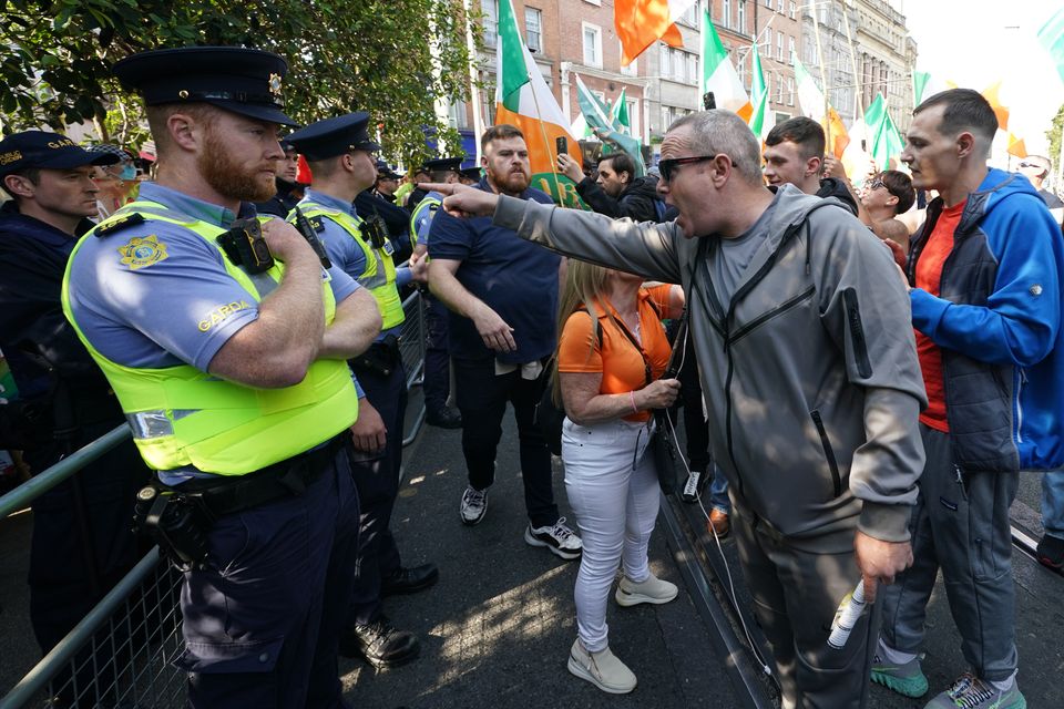 Gardai form a barrier between protesters and counter-protesters on Grafton Street in Dublin city centre (Brian Lawless/PA)