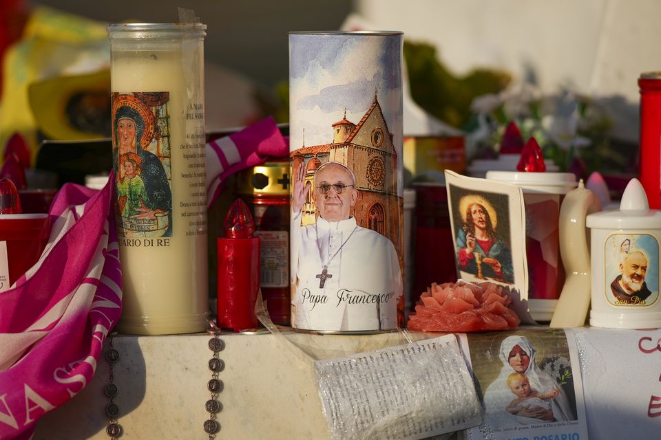 Candles and flowers for Pope Francis outside a hospital in Rome (Andrew Medichini/AP)