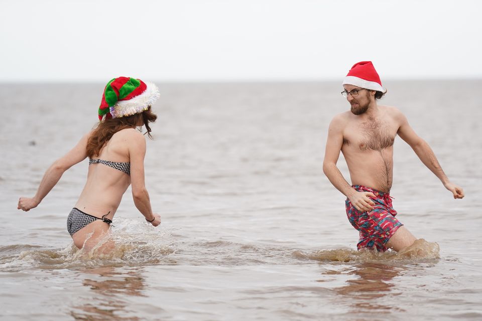 People take part in a Christmas Day dip at Hunstanton in Norfolk (Joe Giddens/PA)