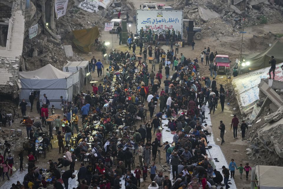 Surrounded by destroyed homes and buildings, Palestinians gather for iftar, the fast-breaking meal during Ramadan in Beit Lahia, northern Gaza Strip (Jehad Alshrafi/AP)