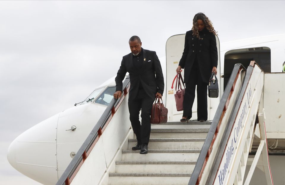 Malawi vice president Saulos Chilima, left, and his wife Mary disembark from a plane upon his return from South Korea in Lillongwe on Sunday, June 9 (STR/AP)