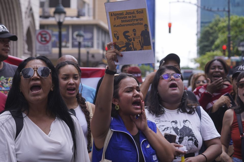 People protest outside the prosecutor’s office against the disappearance of four children (Cesar Munoz/AP)