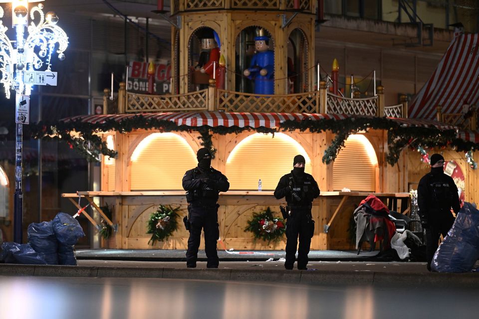 Police stand at the Christmas market in Magdeburg. (Hendrik Schmidt/dpa via AP)