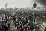 thumbnail: Palestinians gather at the site of a security compound used by the Islamic group Hamas following an Israeli missile strike in Rafah, southern Gaza Strip, Saturday, Dec. 27, 2008. Israeli warplanes demolished dozens of Hamas security compounds across Gaza on Saturday in unprecedented waves of simultaneous air strikes. Gaza medics said more than 120 people were killed and more than 250 wounded.(AP Photo/Hatem Omar)