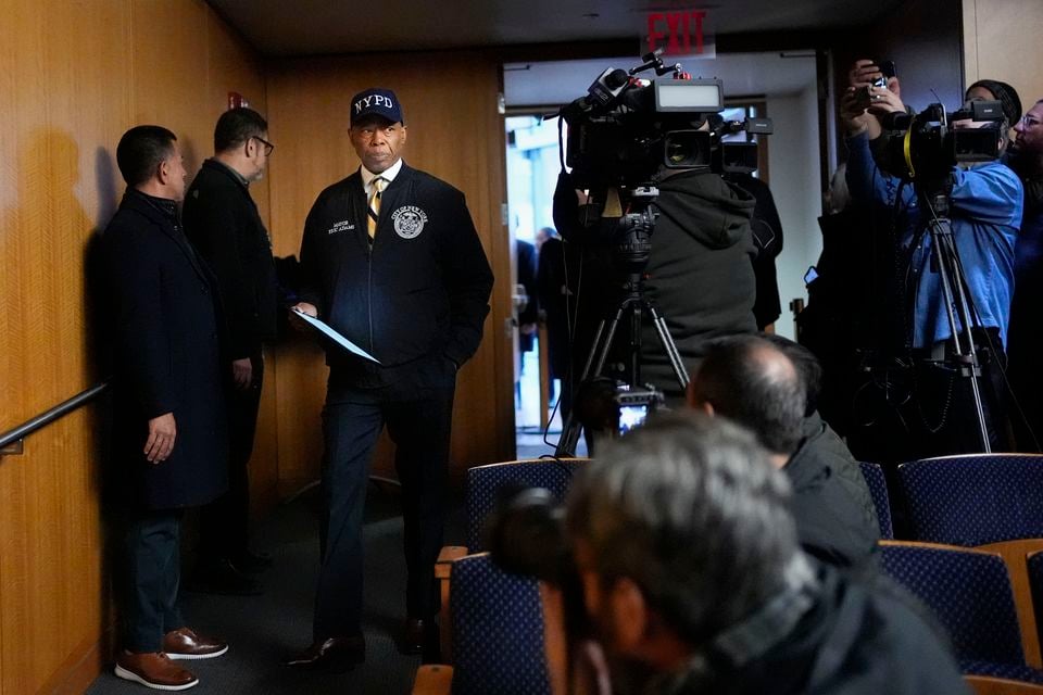 New York City mayor Eric Adams, third from left, arriving at a news conference on Tuesday (Seth Wenig/AP)