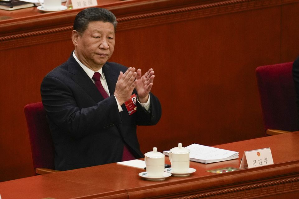 Chinese President Xi Jinping applauds during the opening session of the National People’s Congress at the Great Hall of the People in Beijing (Andy Wong/AP)