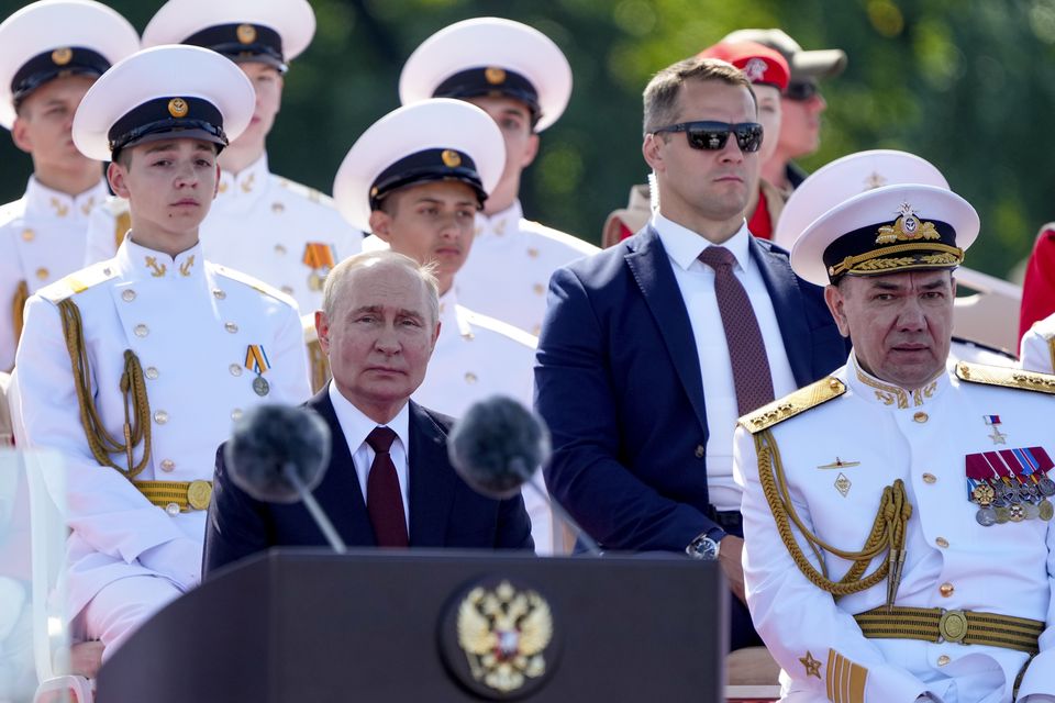 President Vladimir Putin delivers his speech flanked by Russian Navy Commander-in-Chief Admiral Alexander Moiseyev, right, during the Navy Day parade in St Petersburg (Dmitri Lovetsky/Pool/AP)