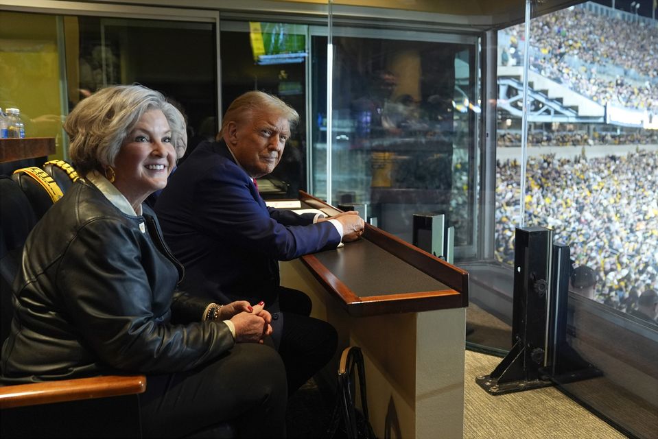 Mr Trump sits with Susie Wiles at an American football game (Evan Vucci/AP, Pool)