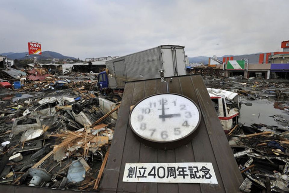 A clock that appears to indicate the time when a tsunami struck lies among the rubble in the city of Kesennuma, northeastern Japan, on Tuesday March 15, 2011. The Japanese characters read: "40th Anniversary of Foundation."