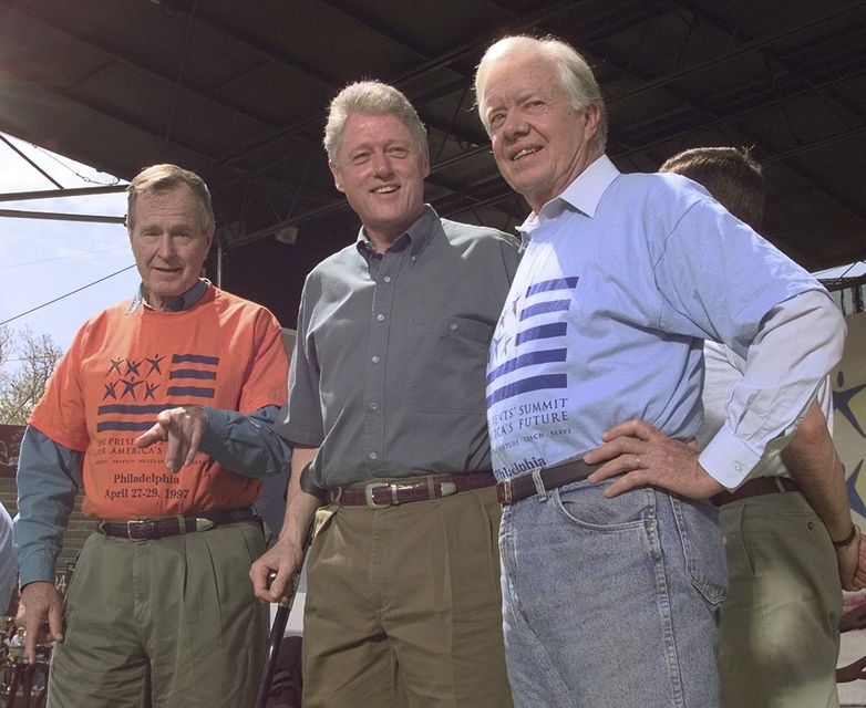 Former presidents George Bush, left, and Jimmy Carter, right, with Bill Clinton (CTR/PA)