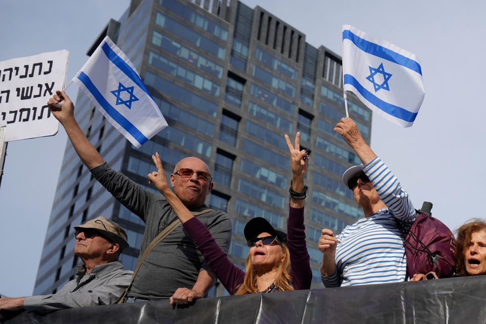 Supporters of Israel’s Prime Minister Benjamin Netanyahu gather outside a court in Tel Aviv, Israel (Ariel Schalit/AP)