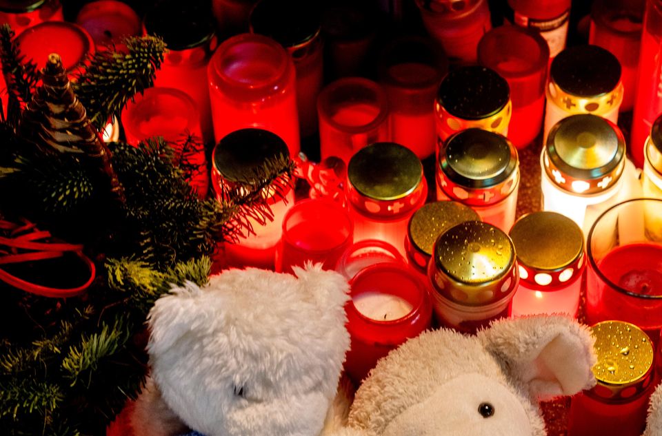 Teddy bears and candles have been left near the scene of the incident (Michael Probst/AP)