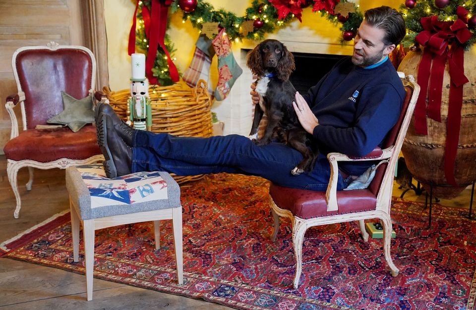 Dog handler Sean Welland with spaniel Elspeth (Jonathan Brady/PA)