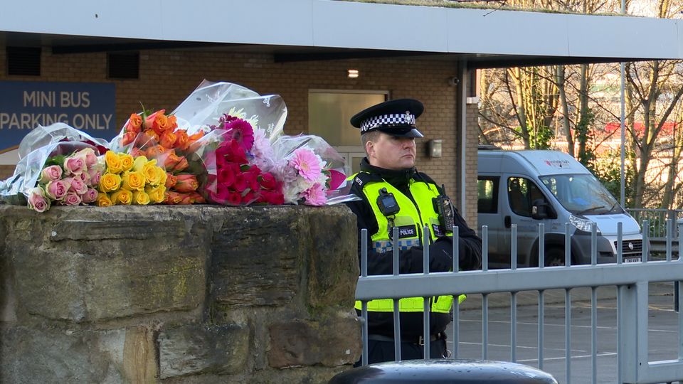 Floral tributes left outside All Saints Catholic High School (Richard McCarthy/PA)