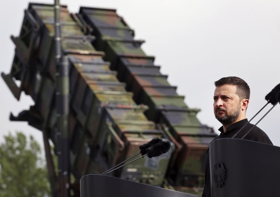 President Volodymyr Zelensky stands in front of a Patriot air defence missile system (Jens Buettner/dpa via AP)