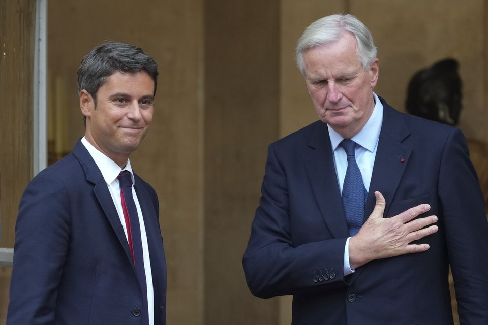 New prime minister of France, Michel Barnier, right, and outgoing French prime minister Gabriel Attal arrive for a handover ceremony in Paris on Thursday (Michel Euler/AP)