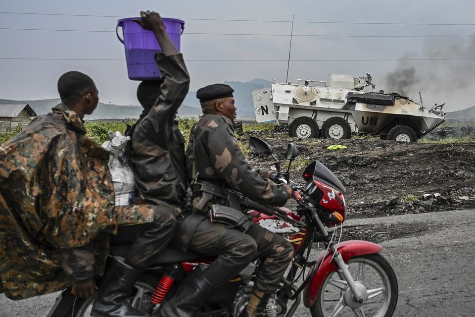 A UN armoured personnel carrier burns on the outskirts of Goma (Moses Sawasawa/AP)