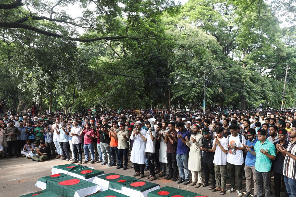 Students advocating for reform held a mock funeral at Dhaka University in memory of those who died during clashes on Wednesday (Rajib Dhar/AP)