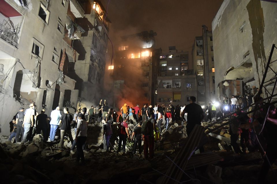 People conduct search and rescue works around the demolished apartment building aftermath of Israeli attack on the Nowayri neighborhood of Beirut, the capital of Lebanon. Photo: Getty