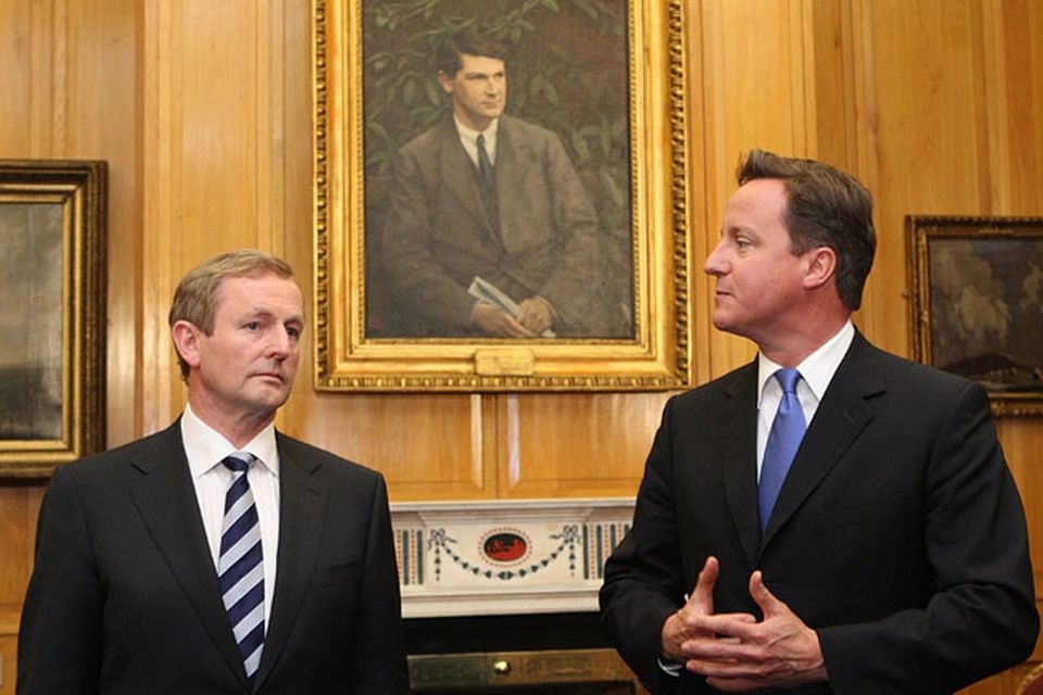 Irish Taoiseach  Enda Kenny talks with Britain's Prime Minister David Cameron at Government buildings where the two held talks prior to attending the state dinner in honour of Queen Elizabeth II