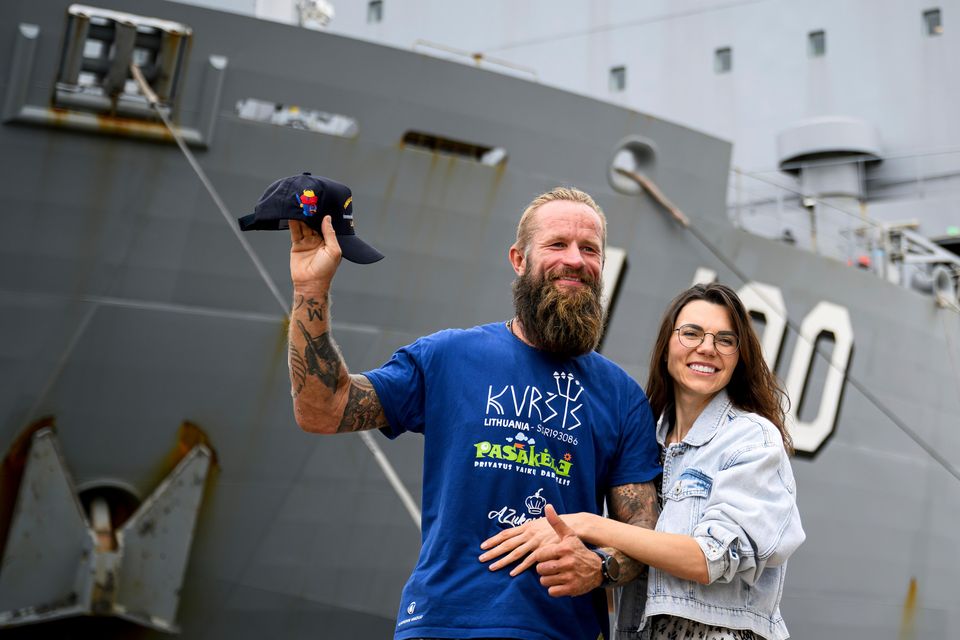 Rescued Lithuanian rower Aurimas Mockus, left, and his wife Sonata Mockuviene h in front of the HMAS Choules (Bianca De Marchi/AAP Image via AP)