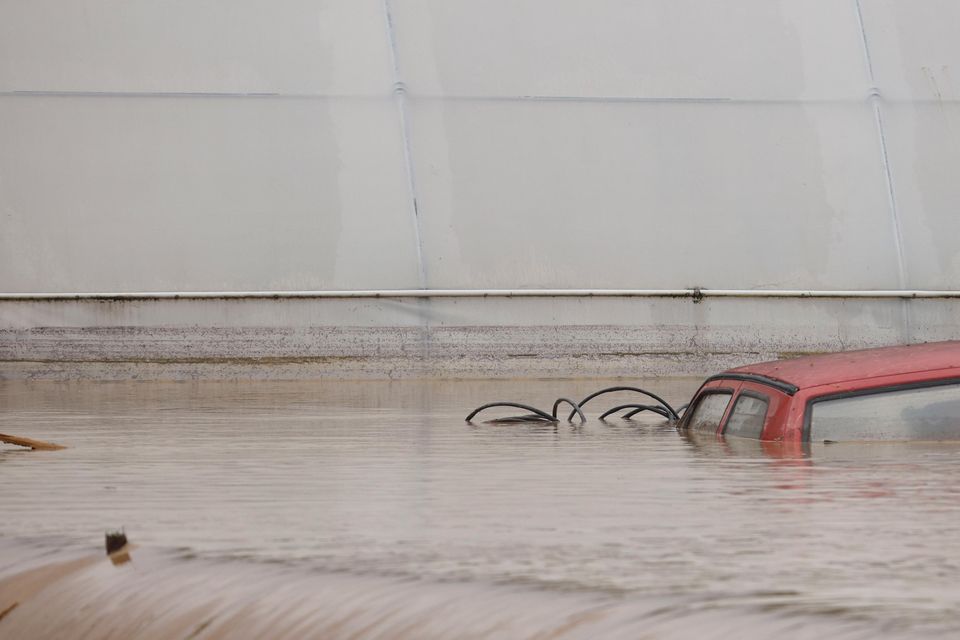 A car is submerged in floodwaters outside an apartment building in the northern Bosnian village of Kiseljak (Armin Durgut/AP)