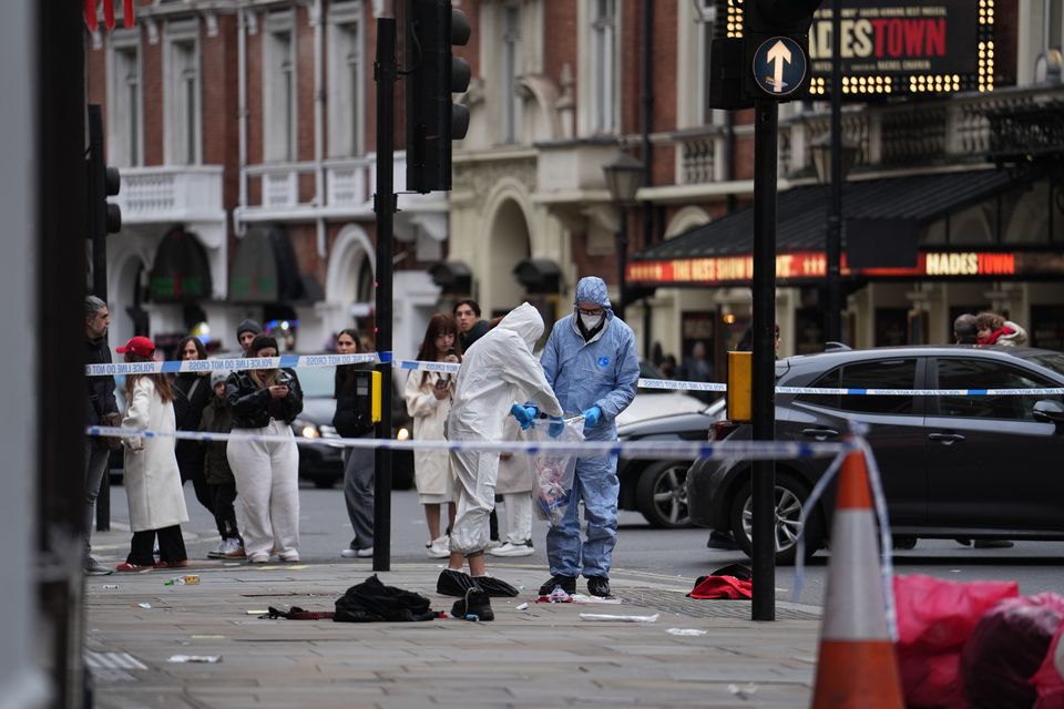 Forensic investigators collect evidence at the scene on Shaftesbury Avenue(Jordan Pettitt/PA)