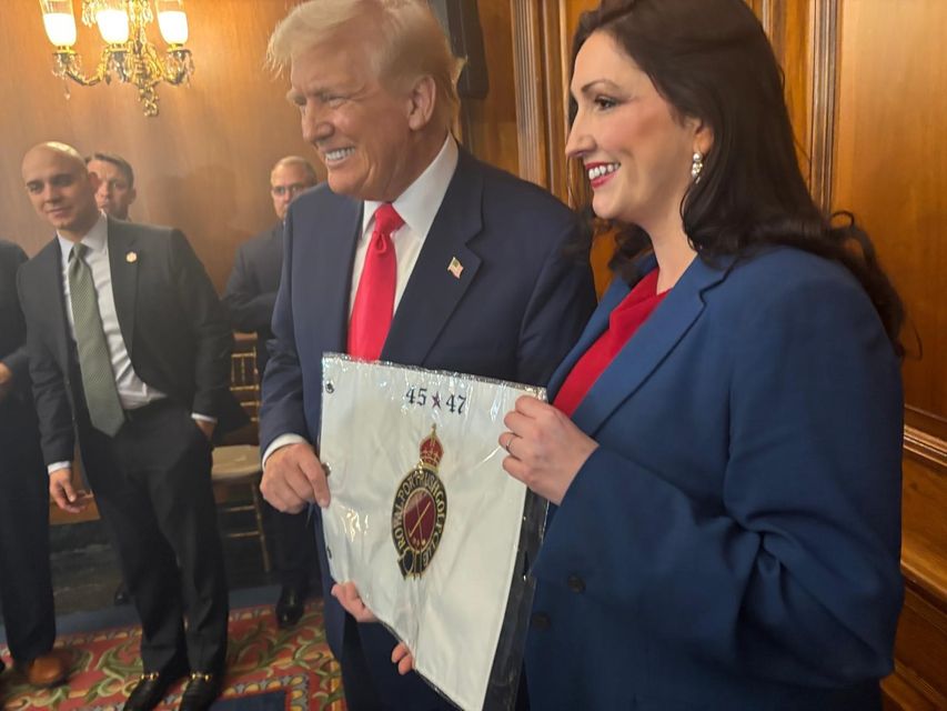 Emma Little-Pengelly presents Donald Trump with a personalised flag from Royal Portrush Golf Club, at the US Capitol in Washington DC on Wednesday (DUP/PA)