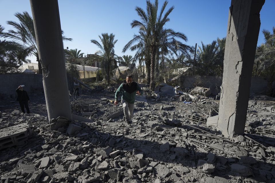 A Palestinian inspects the rubble of a destroyed building following an overnight Israeli strike in Deir al-Balah, Gaza Strip (Abdel Kareem Hana/AP)