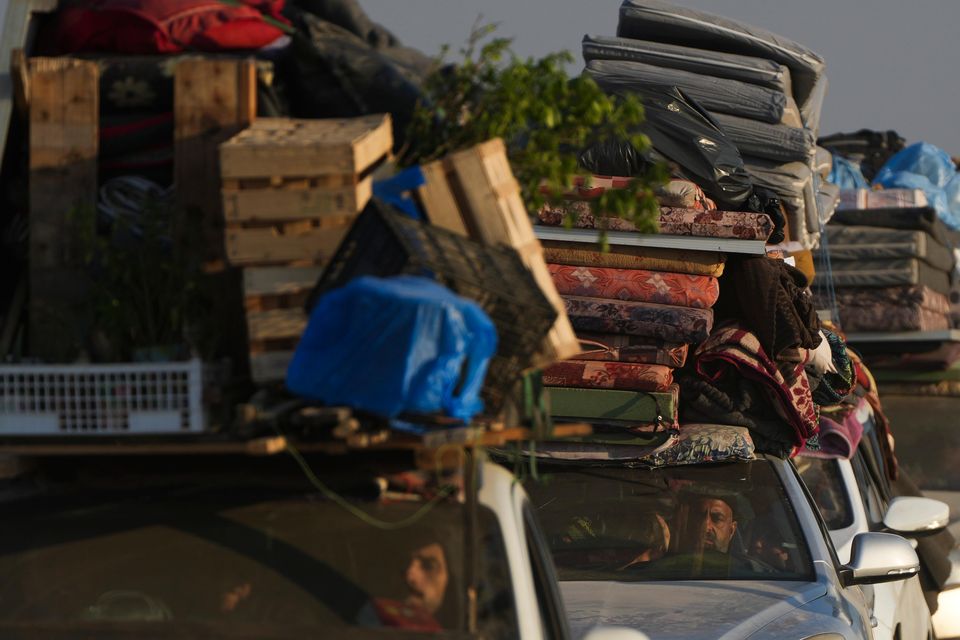 Displaced Palestinians make their way from central Gaza to their homes in the northern Gaza Strip (Abdel Kareem Hana/AP)